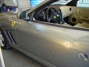 Dent in door of silver Ferrari